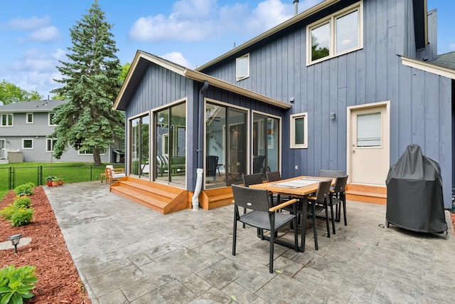 3720 Ximines Ln N, Plymouth, MN 55441 - back of property with a sunroom, board and batten siding, and a patio