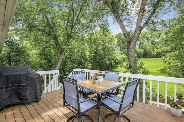 324 Meadow Run Dr SW, Rochester, MN 55902 - wooden deck featuring outdoor dining space, a yard, area for grilling, and view of wooded area