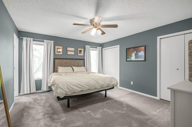 324 Meadow Run Dr SW, Rochester, MN 55902 - bedroom with multiple closets, a textured ceiling, carpet flooring, baseboards, and a ceiling fan
