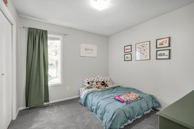 324 Meadow Run Dr SW, Rochester, MN 55902 - carpeted bedroom with a textured ceiling, baseboards, and a closet