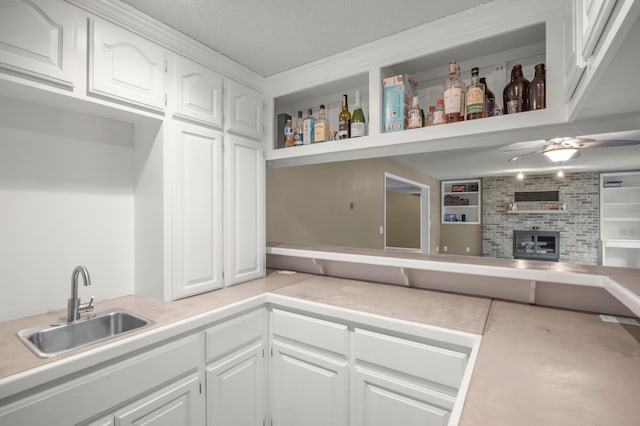 324 Meadow Run Dr SW, Rochester, MN 55902 - kitchen with a sink, white cabinetry, ceiling fan, and light countertops