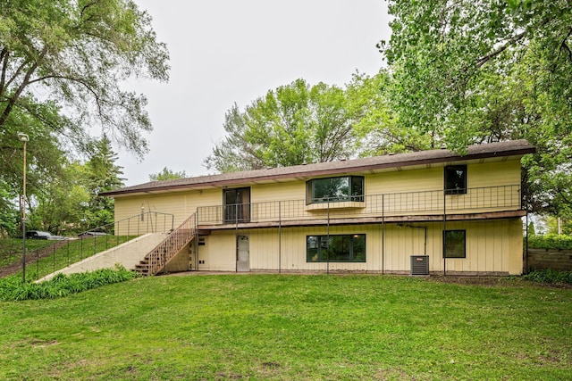 2065 124th Ln NW, Coon Rapids, MN 55448 - back of property with stairway, central air condition unit, and a wooden deck