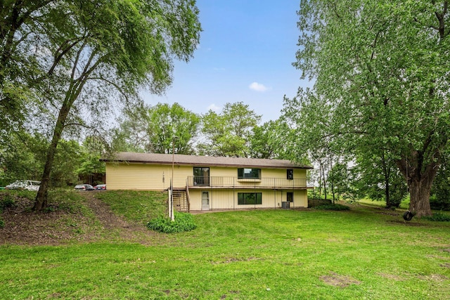 2065 124th Ln NW, Coon Rapids, MN 55448 - rear view of property featuring a yard, central air condition unit, and a wooden deck