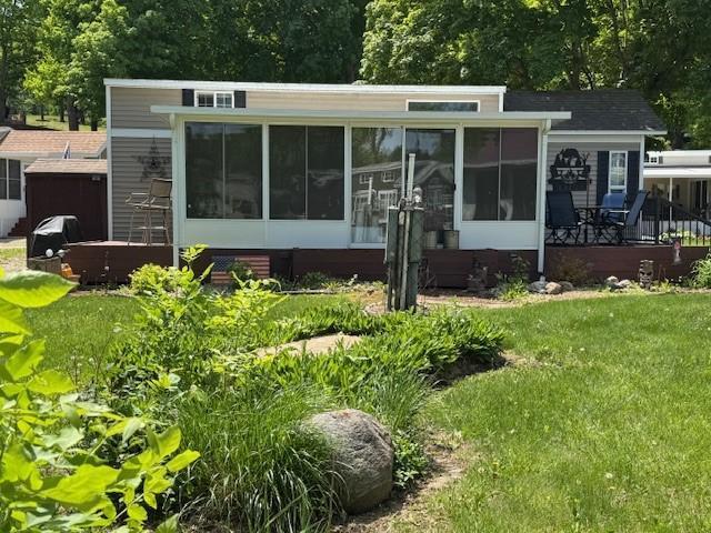 2221 Reubens Ln SW Unit 20, Farwell, MN 56327 - view of front facade with a sunroom and a front yard