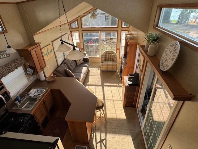 2221 Reubens Ln SW Unit 20, Farwell, MN 56327 - living room with a ceiling fan, healthy amount of natural light, and high vaulted ceiling