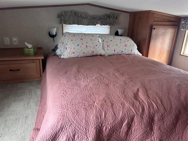2221 Reubens Ln SW Unit 20, Farwell, MN 56327 - bedroom featuring ornamental molding, carpet floors, and vaulted ceiling