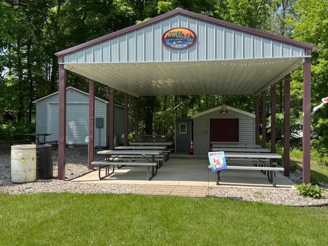 2221 Reubens Ln SW Unit 20, Farwell, MN 56327 - view of community with view of scattered trees, a storage shed, a lawn, and a carport