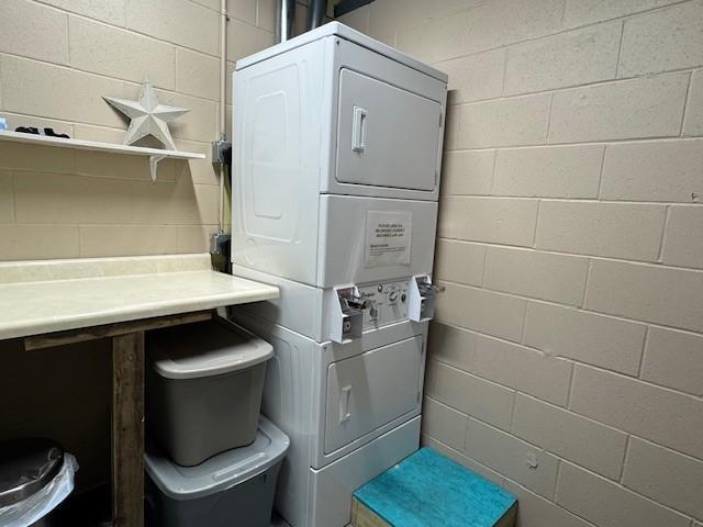 2221 Reubens Ln SW Unit 20, Farwell, MN 56327 - laundry room with stacked washer and clothes dryer and concrete block wall