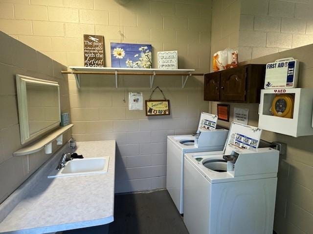 2221 Reubens Ln SW Unit 20, Farwell, MN 56327 - laundry area with washer and dryer, concrete block wall, and cabinet space