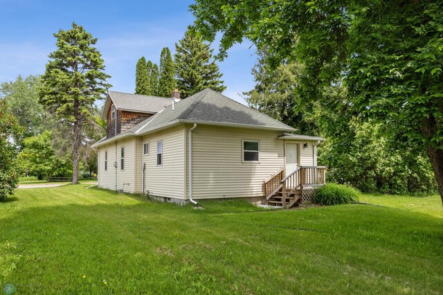 406 4th Ave NW, Barnesville, MN 56514 - view of side of home with roof with shingles, a yard, and a chimney