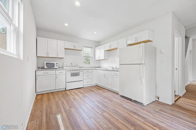 406 4th Ave NW, Barnesville, MN 56514 - kitchen with white appliances, white cabinets, light wood-type flooring, and recessed lighting