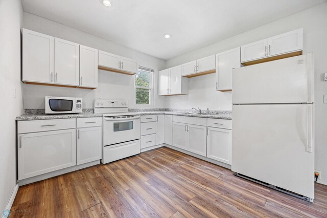 406 4th Ave NW, Barnesville, MN 56514 - kitchen with white appliances, white cabinets, wood finished floors, a sink, and recessed lighting