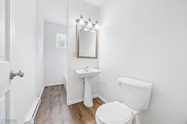 406 4th Ave NW, Barnesville, MN 56514 - bathroom featuring a baseboard heating unit, toilet, wood finished floors, and baseboards