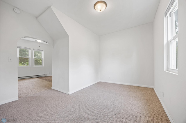 406 4th Ave NW, Barnesville, MN 56514 - empty room with baseboard heating, carpet flooring, a smoke detector, arched walkways, and baseboards