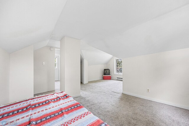 406 4th Ave NW, Barnesville, MN 56514 - unfurnished bedroom featuring carpet, lofted ceiling, a baseboard radiator, and baseboards