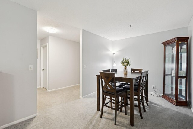 5697 Green Circle Dr Unit 216, Minnetonka, MN 55343 - dining room featuring carpet flooring and baseboards