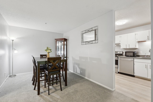 5697 Green Circle Dr Unit 216, Minnetonka, MN 55343 - dining area with baseboards and light colored carpet
