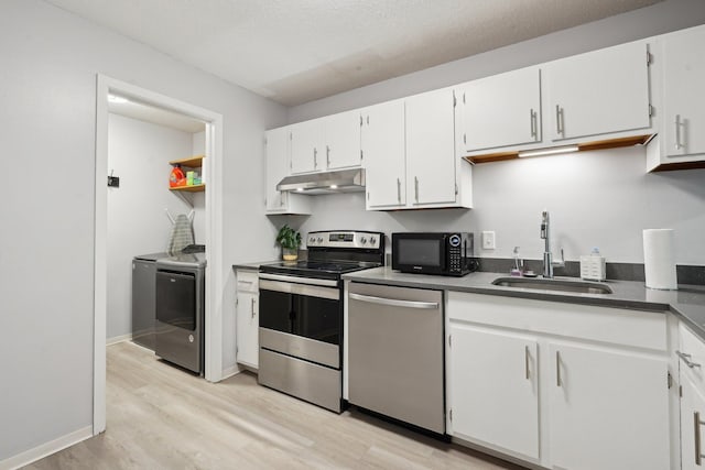 5697 Green Circle Dr Unit 216, Minnetonka, MN 55343 - kitchen featuring stainless steel appliances, separate washer and dryer, under cabinet range hood, a sink, and light wood-style floors
