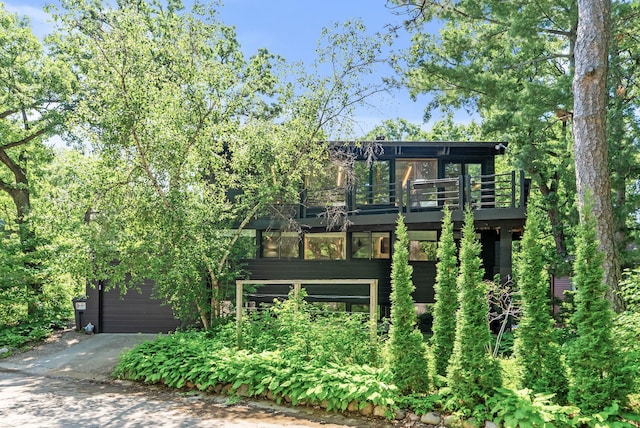 2867 Burnham Blvd, Minneapolis, MN 55416 - contemporary home featuring a wooden deck, a garage, and driveway