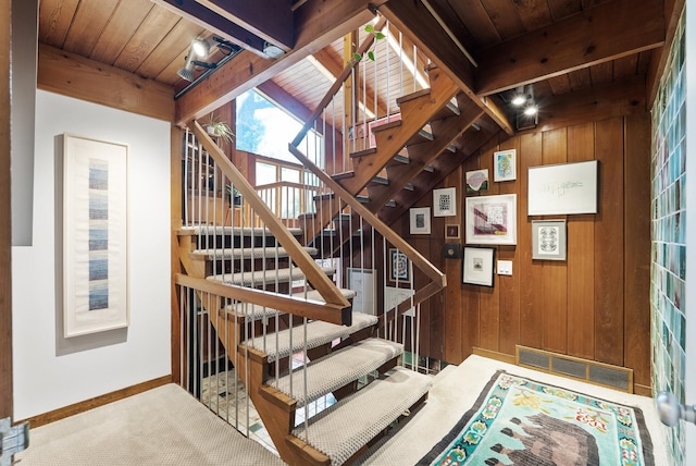 2867 Burnham Blvd, Minneapolis, MN 55416 - stairs featuring wood ceiling with exposed beams, wooden walls, baseboards, and carpet floors