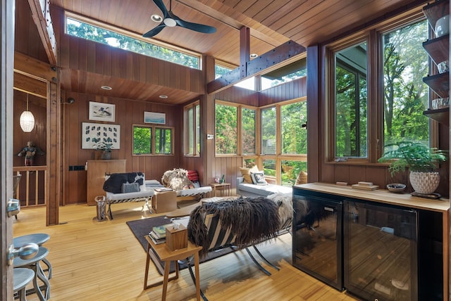 2867 Burnham Blvd, Minneapolis, MN 55416 - living room with a ceiling fan, wood walls, beverage cooler, wood finished floors, and wood ceiling