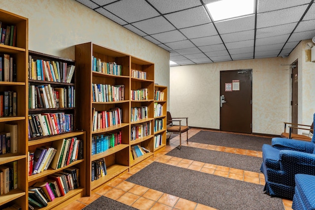 183 Little Canada Rd E Unit 310, Little Canada, MN 55117 - living area with bookshelves, tile patterned floors, and a paneled ceiling