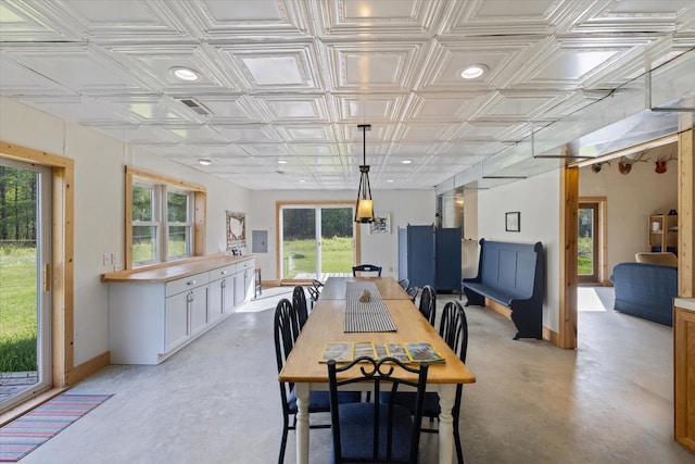 11556 Blackwood Rd, Floodwood Twp, MN 55736 - dining area with finished concrete floors, healthy amount of natural light, baseboards, and an ornate ceiling