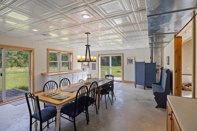 11556 Blackwood Rd, Floodwood Twp, MN 55736 - dining room with an ornate ceiling, finished concrete floors, a chandelier, plenty of natural light, and baseboards