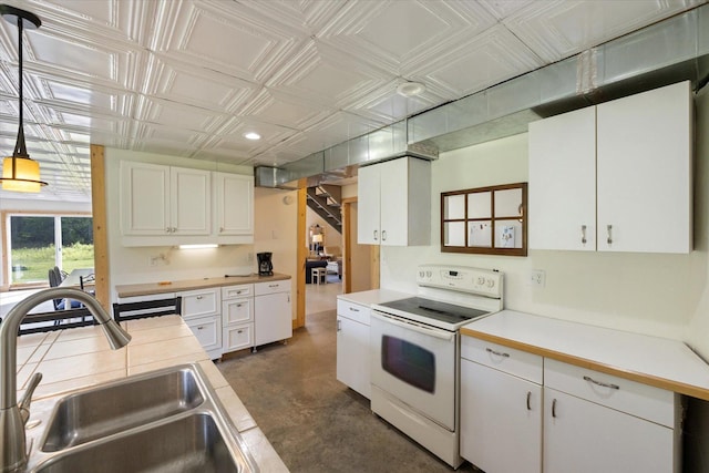 11556 Blackwood Rd, Floodwood Twp, MN 55736 - kitchen with electric stove, a sink, concrete floors, an ornate ceiling, and white cabinets