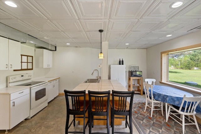 11556 Blackwood Rd, Floodwood Twp, MN 55736 - kitchen with white appliances, a sink, recessed lighting, white cabinets, and decorative light fixtures