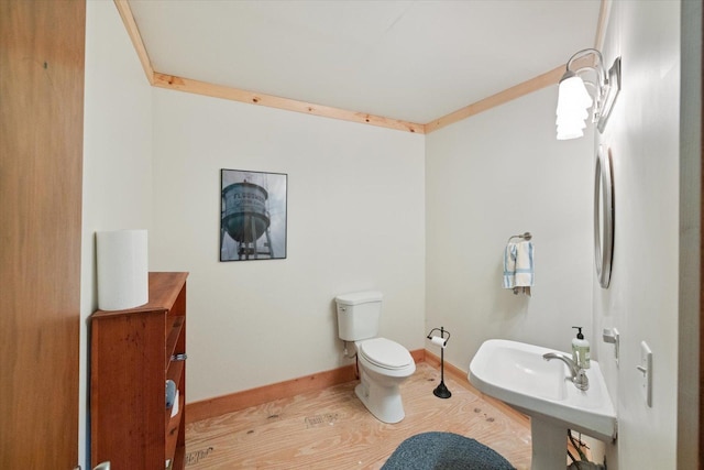 11556 Blackwood Rd, Floodwood Twp, MN 55736 - bathroom featuring toilet, wood finished floors, and baseboards
