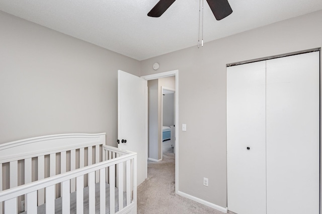 2205 Valders Ave N, Golden Valley, MN 55427 - unfurnished bedroom featuring light carpet, a closet, a nursery area, and a ceiling fan