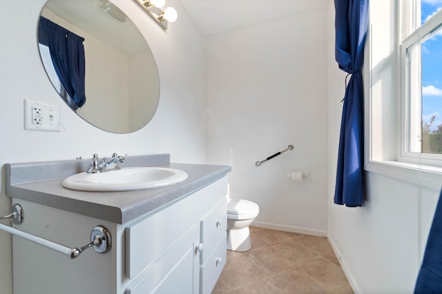 601 22nd Ave W, Duluth, MN 55806 - bathroom with vanity, toilet, tile patterned flooring, and baseboards
