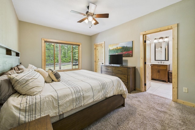 1268 Nellie Lake Ln NE, Longville, MN 56655 - bedroom featuring light carpet, baseboards, ensuite bathroom, a ceiling fan, and a sink