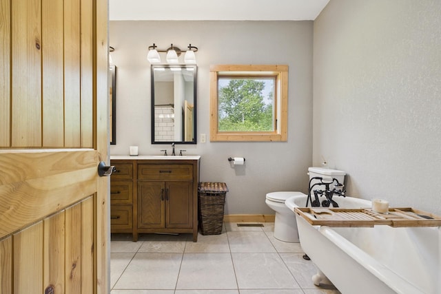 1268 Nellie Lake Ln NE, Longville, MN 56655 - bathroom featuring a freestanding tub, vanity, toilet, tile patterned floors, and baseboards