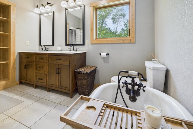 1268 Nellie Lake Ln NE, Longville, MN 56655 - bathroom with double vanity, a freestanding bath, toilet, and tile patterned floors