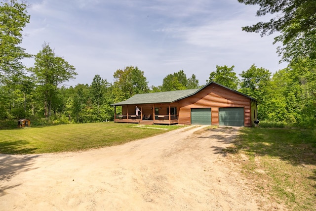 1268 Nellie Lake Ln NE, Longville, MN 56655 - view of front facade featuring driveway, a front yard, a porch, a garage, and log veneer siding