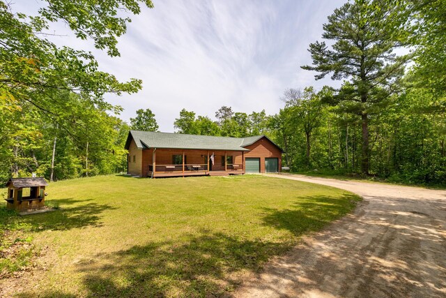 1268 Nellie Lake Ln NE, Longville, MN 56655 - view of front of home featuring a front yard, driveway, covered porch, and a garage