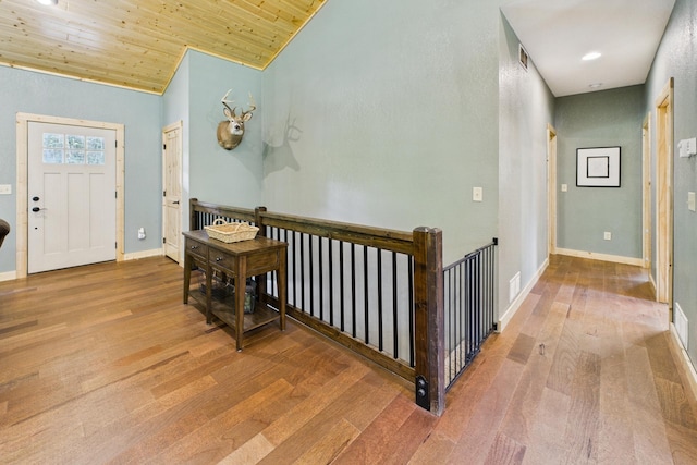 1268 Nellie Lake Ln NE, Longville, MN 56655 - foyer entrance featuring wood finished floors, baseboards, vaulted ceiling, and wooden ceiling