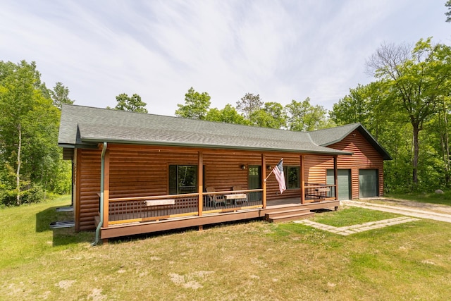 1268 Nellie Lake Ln NE, Longville, MN 56655 - view of front of property with an attached garage, a front lawn, concrete driveway, and log veneer siding