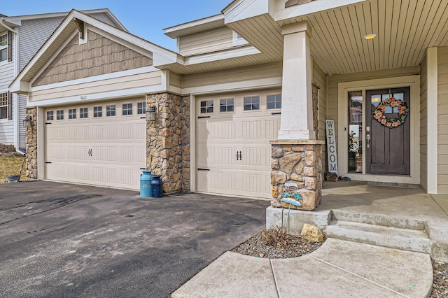 9602 7th St N, Lake Elmo, MN 55042 - property entrance with stone siding, driveway, and a garage