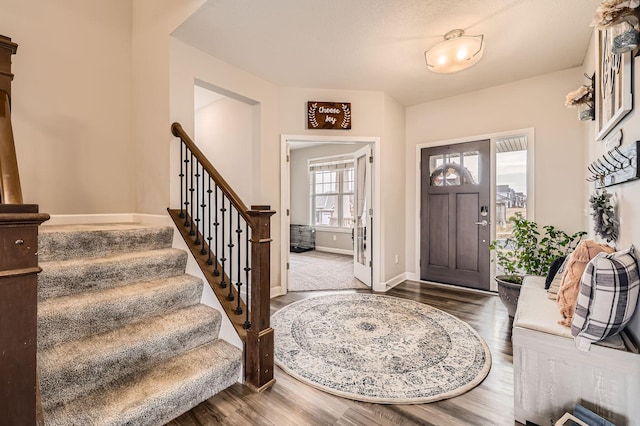 9602 7th St N, Lake Elmo, MN 55042 - foyer featuring dark wood finished floors, stairway, and baseboards