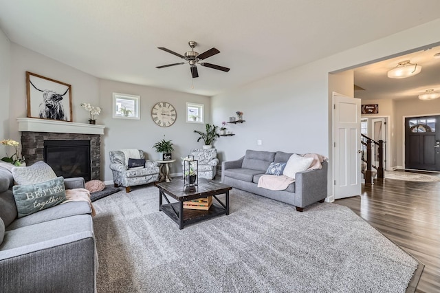 9602 7th St N, Lake Elmo, MN 55042 - living room with wood finished floors, ceiling fan, a stone fireplace, and baseboards