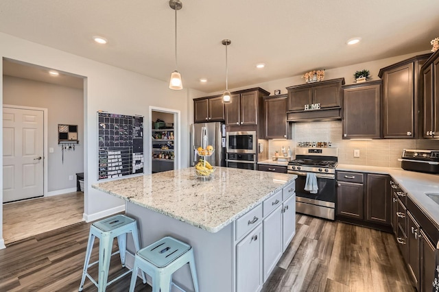 9602 7th St N, Lake Elmo, MN 55042 - kitchen featuring stainless steel appliances, dark wood finished floors, dark brown cabinetry, a kitchen island, and recessed lighting