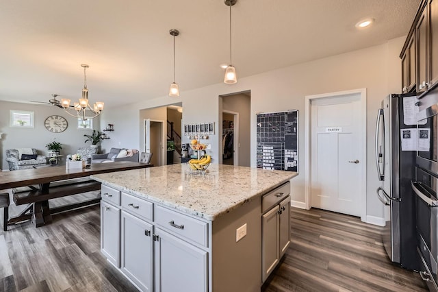9602 7th St N, Lake Elmo, MN 55042 - kitchen with open floor plan, dark wood-type flooring, freestanding refrigerator, a kitchen island, and a chandelier