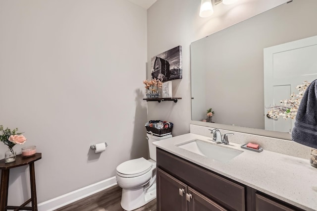 9602 7th St N, Lake Elmo, MN 55042 - bathroom with wood finished floors, toilet, vanity, and baseboards