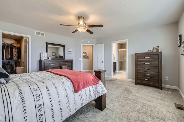 9602 7th St N, Lake Elmo, MN 55042 - bedroom featuring light carpet, baseboards, ensuite bathroom, and ceiling fan