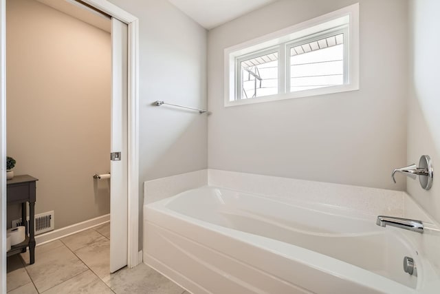 9602 7th St N, Lake Elmo, MN 55042 - bathroom with a garden tub, baseboards, marble look tile flooring, and vanity