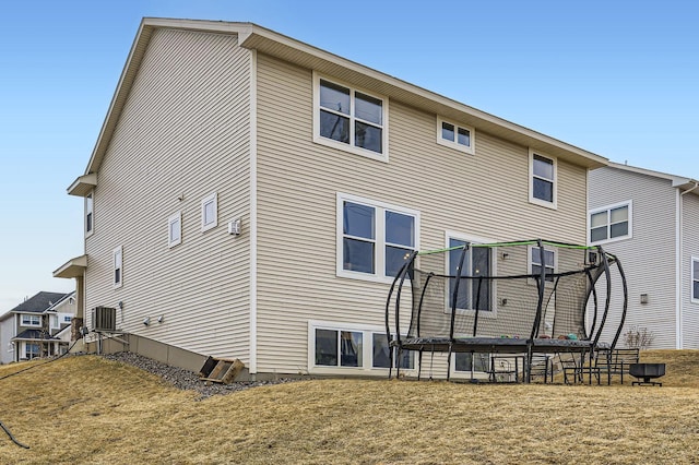 9602 7th St N, Lake Elmo, MN 55042 - back of house with a trampoline and a yard