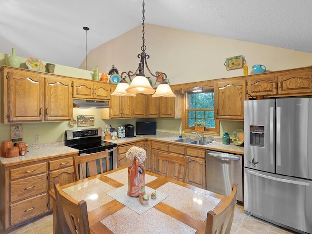 9160 164th Ln NW, Ramsey, MN 55303 - kitchen with stainless steel appliances, a sink, under cabinet range hood, light countertops, and brown cabinets
